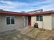 A single story home with desert landscaping, a security screen door, and desert landscaping at 310 E Lake Mead Blvd, North Las Vegas, NV 89030