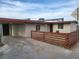 Single story home with a desert landscape, fencing, and covered parking at 310 E Lake Mead Blvd, North Las Vegas, NV 89030