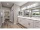 Luxurious bathroom with dual sinks, marble countertops, and a large walk-in closet at 3120 S Torrey Pines Ave, Pahrump, NV 89048