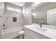 This bathroom offers a shower over the tub with beautiful tile surround and a modern vanity at 3120 S Torrey Pines Ave, Pahrump, NV 89048