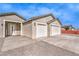 Close-up of a home showcasing a two-car garage, modern door, and neutral color scheme with desert landscaping at 3120 S Torrey Pines Ave, Pahrump, NV 89048
