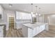 Well-lit kitchen with a center island, stainless appliances, marble countertops, and ample white cabinetry at 3120 S Torrey Pines Ave, Pahrump, NV 89048