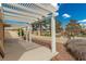 An outdoor patio with a lattice pergola and gravel landscaping at 344 Mill Hollow Rd, Las Vegas, NV 89107