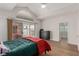 Bedroom features a vaulted ceiling, sliding glass door to backyard, and wood-look flooring at 344 Mill Hollow Rd, Las Vegas, NV 89107