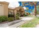 Attractive clubhouse with well-maintained landscaping, trees and an American flag at 344 Mill Hollow Rd, Las Vegas, NV 89107
