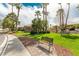 Park area with green grass, walking path, bench and mature landscaping at 344 Mill Hollow Rd, Las Vegas, NV 89107