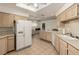 Bright kitchen with white appliances and countertops, and wood-look cabinets at 344 Mill Hollow Rd, Las Vegas, NV 89107