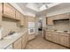 Bright kitchen with white appliances and countertops and wood-look cabinets at 344 Mill Hollow Rd, Las Vegas, NV 89107