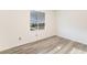 A cozy bedroom with gray floors and a window looking outside at 3540 Estes Park Dr, Las Vegas, NV 89122