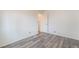 A bedroom with wood-look flooring and a doorway to another room at 3540 Estes Park Dr, Las Vegas, NV 89122