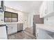 Modern kitchen features stainless steel appliances, white cabinets, and a large window with ample natural light at 3540 Estes Park Dr, Las Vegas, NV 89122