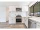 Kitchen featuring stainless steel appliances, white cabinets, and sleek countertops at 3540 Estes Park Dr, Las Vegas, NV 89122