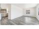 Open living and kitchen featuring durable laminate flooring and bright white walls at 3540 Estes Park Dr, Las Vegas, NV 89122