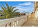 View from a balcony showing a neighborhood street with a palm tree in the foreground at 3604 N Campbell Rd, Las Vegas, NV 89129