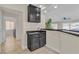 Stylish bar area with dark cabinetry and countertops, next to open floor plan and laundry area at 3604 N Campbell Rd, Las Vegas, NV 89129