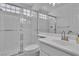 Modern bathroom featuring a large walk-in shower with glass block details, a clean, white vanity at 3604 N Campbell Rd, Las Vegas, NV 89129