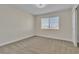 Empty bedroom with light gray carpet, a window with blinds, and a ceiling fan at 3604 N Campbell Rd, Las Vegas, NV 89129