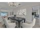 Elegant dining room with modern chandelier, stylish table setting, and seamless flow to the living spaces at 3604 N Campbell Rd, Las Vegas, NV 89129