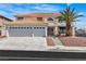 Charming two-story home with a three-car garage, landscaped yard, and a beautiful mature palm tree at 3604 N Campbell Rd, Las Vegas, NV 89129