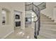 Spacious foyer featuring a grand staircase, view of living spaces, and neutral color palette at 3604 N Campbell Rd, Las Vegas, NV 89129