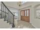 Elegant foyer with a staircase, chandelier, and double door entry, creating a grand entrance at 3604 N Campbell Rd, Las Vegas, NV 89129