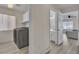 Convenient laundry room with side-by-side washer and dryer units, with a view into the nearby bathroom at 3604 N Campbell Rd, Las Vegas, NV 89129