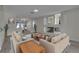 Bright living room with modern furnishings, a fireplace, and an open layout connecting to the dining area at 3604 N Campbell Rd, Las Vegas, NV 89129