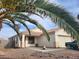 Charming home exterior with desert landscaping, a tile roof, and palm tree at 3616 Rose Canyon Dr, North Las Vegas, NV 89032
