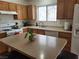 Well-lit kitchen with a large island, white appliances, and wood cabinets at 3616 Rose Canyon Dr, North Las Vegas, NV 89032