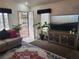 Cozy living room with natural light, comfortable seating, and a large television at 3616 Rose Canyon Dr, North Las Vegas, NV 89032