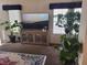 Cozy living room featuring a large screen TV, decorative furniture, and indoor greenery at 3616 Rose Canyon Dr, North Las Vegas, NV 89032