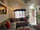 Inviting living room featuring a sectional sofa, modern lighting, and decorative mirror at 3616 Rose Canyon Dr, North Las Vegas, NV 89032