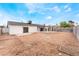 Wide view of the spacious backyard with the home and covered patio in view at 3915 Delling Ct, Las Vegas, NV 89104
