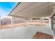 Covered patio area with white support beams and a view of the large backyard at 3915 Delling Ct, Las Vegas, NV 89104