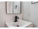 Bathroom featuring modern black fixtures, a mirror, and a sleek vanity at 3915 Delling Ct, Las Vegas, NV 89104