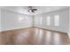 Bright bedroom with a ceiling fan, wood flooring, and multiple windows at 3915 Delling Ct, Las Vegas, NV 89104