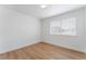 Bedroom with wood-look floors, neutral walls, and a window overlooking the neighborhood at 3915 Delling Ct, Las Vegas, NV 89104