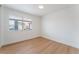 Bright bedroom featuring wood-look floors, a large window, and neutral walls at 3915 Delling Ct, Las Vegas, NV 89104