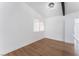 Bright bedroom with wood flooring, white walls, modern lighting, and a large window at 3915 Delling Ct, Las Vegas, NV 89104