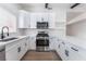 Bright kitchen features stainless steel appliances and modern countertops with white cabinets at 3915 Delling Ct, Las Vegas, NV 89104