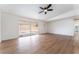 Open living space with bright floors, a ceiling fan, and a sliding glass door to a covered outdoor area at 3915 Delling Ct, Las Vegas, NV 89104