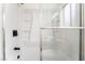 Shower-tub combo with white tile and modern black fixtures at 3915 Delling Ct, Las Vegas, NV 89104