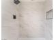 Walk-in shower featuring marbled tiling and sleek, modern fixtures at 3915 Delling Ct, Las Vegas, NV 89104