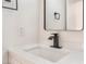 Close-up of a white vanity with a black faucet and rectangular mirror at 3915 Delling Ct, Las Vegas, NV 89104