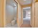 Hallway featuring a full bathroom and an entrance into a carpeted bedroom at 43 E Agate Ave # 305, Las Vegas, NV 89123
