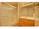 Bathroom with a glass shower, a sink with a wood cabinet, and neutral paint at 43 E Agate Ave # 305, Las Vegas, NV 89123