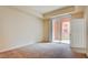 Bedroom featuring an exterior sliding door, neutral paint, and carpeted flooring at 43 E Agate Ave # 305, Las Vegas, NV 89123