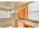 Bright kitchen featuring white appliances, light wood cabinets, granite countertops, and a breakfast bar at 43 E Agate Ave # 305, Las Vegas, NV 89123