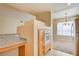 Bright kitchen view featuring white appliances, light wood cabinets, granite countertops, and tile floor at 43 E Agate Ave # 305, Las Vegas, NV 89123
