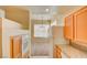 Traditional kitchen with granite counters, light wood cabinets, and an opening into the carpeted dining room at 43 E Agate Ave # 305, Las Vegas, NV 89123